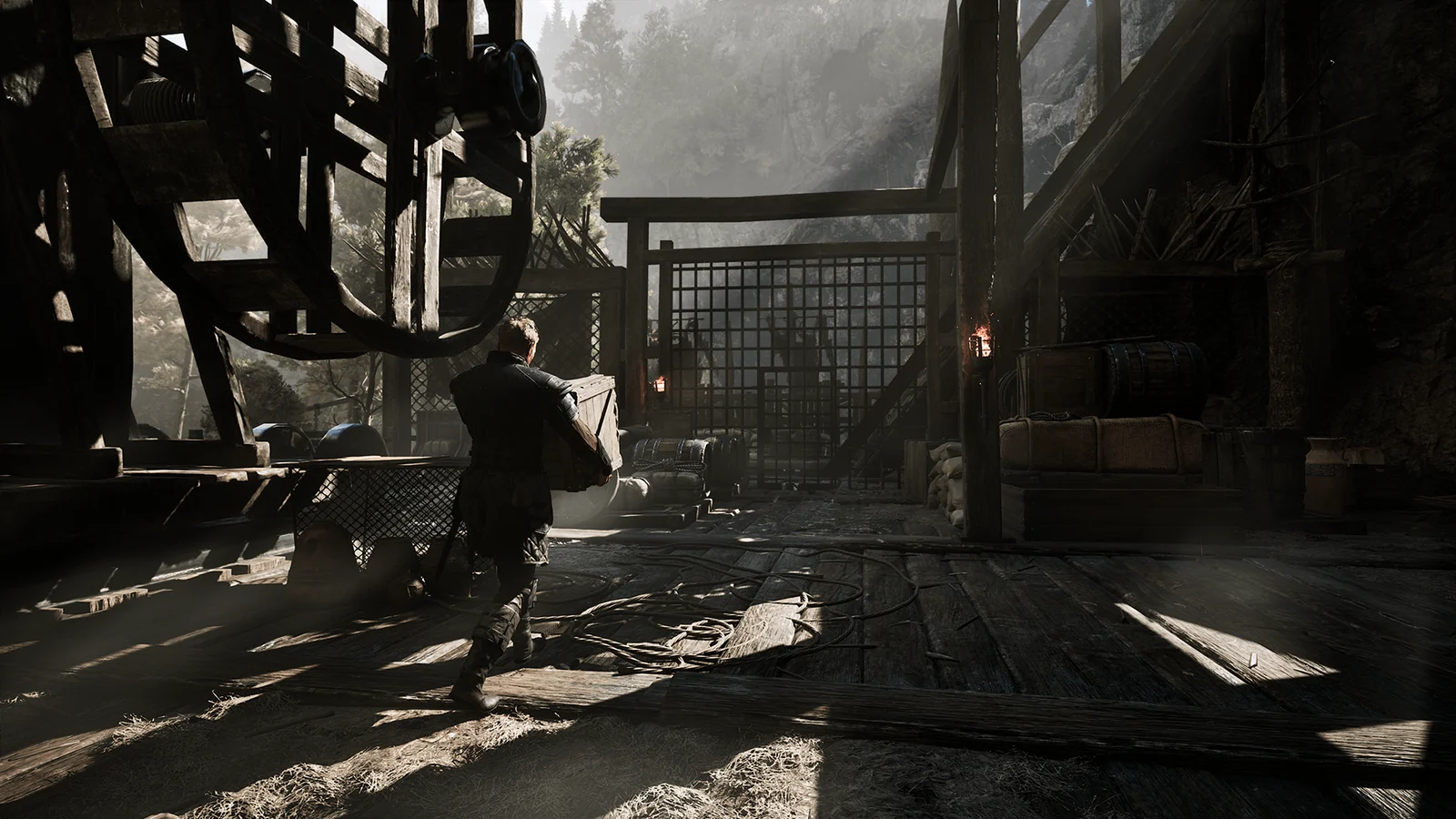 Official Gothic 1 Remake screenshot of a prisoner carrying supplies through the Mining Colony